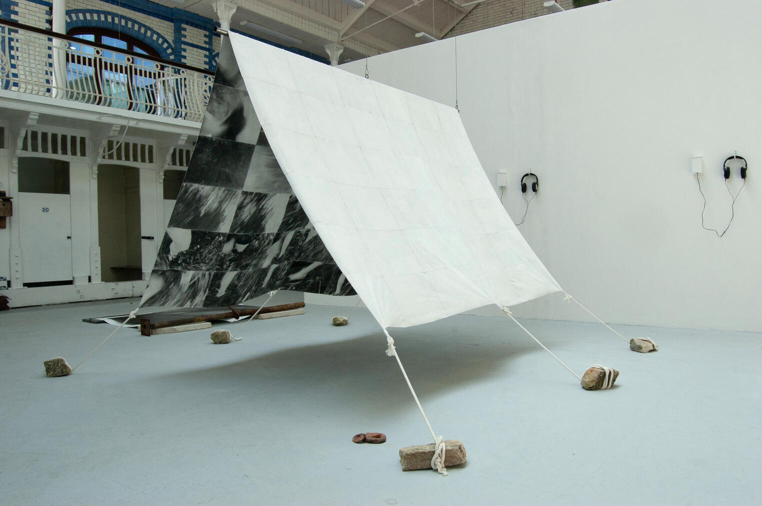 Passage Hand-sewn patchwork tent, cinematic still pigment transfer on fabric, steel cable, rope, limestone, foraged river clay hag stones. 250 x 270 x 182 cm 2026