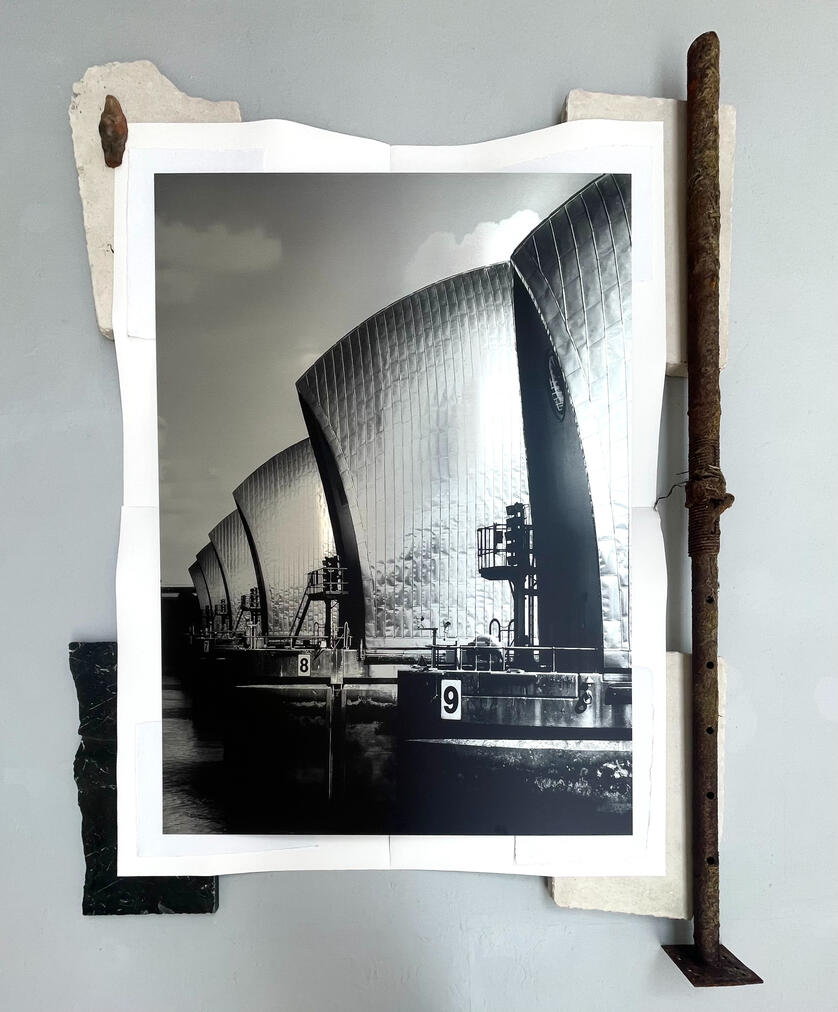 51.494934° N 0.037628° W Print on brushed aluminium, Portland stone, Wandsworth marble, mudlarked industrial metal, watercolour paper, recycled cotton paper, foraged river clay Tamesis figurine. 160 x 200 x 18 cm 2026